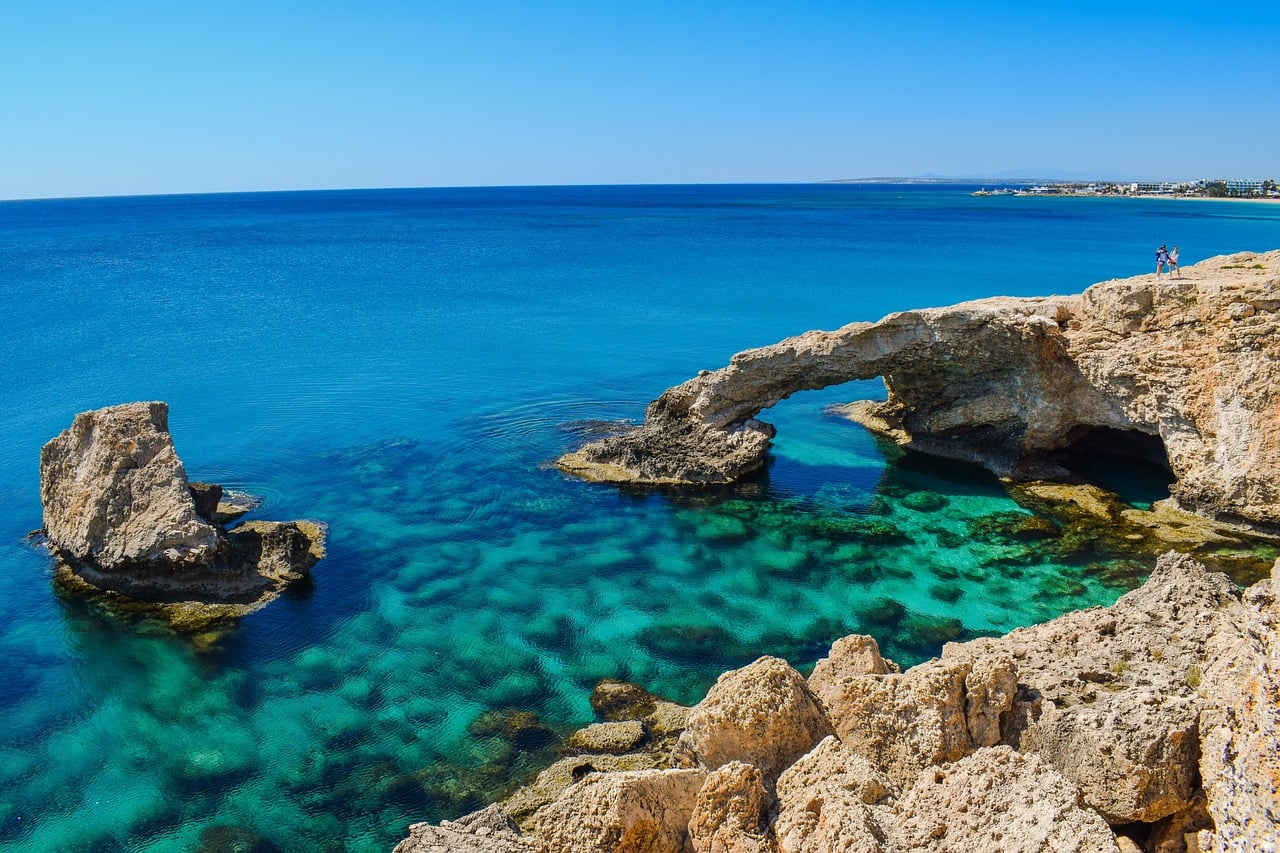 Turquoise water and a rock arch on the Cyprus coast